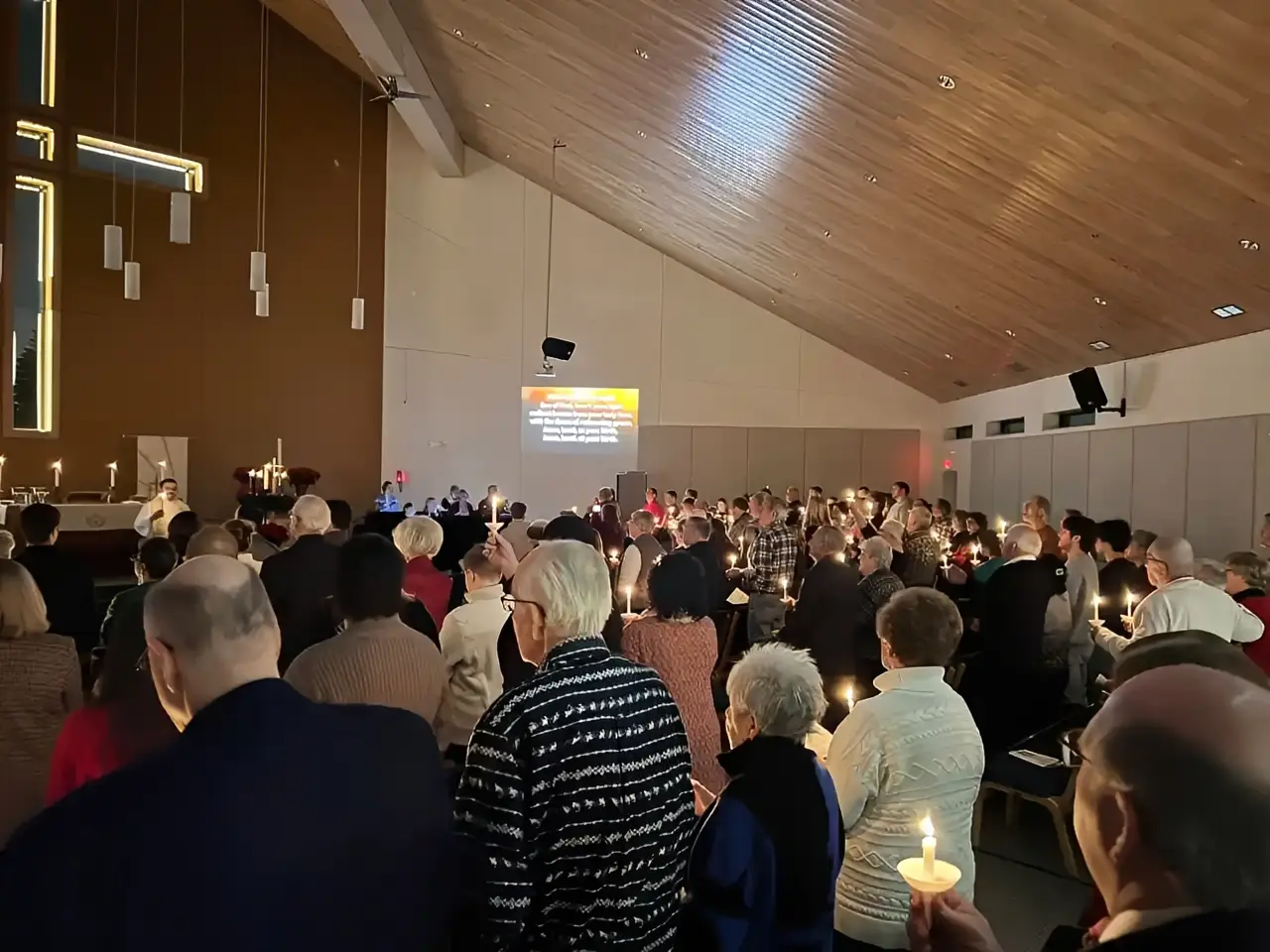Church service with candlelit congregation