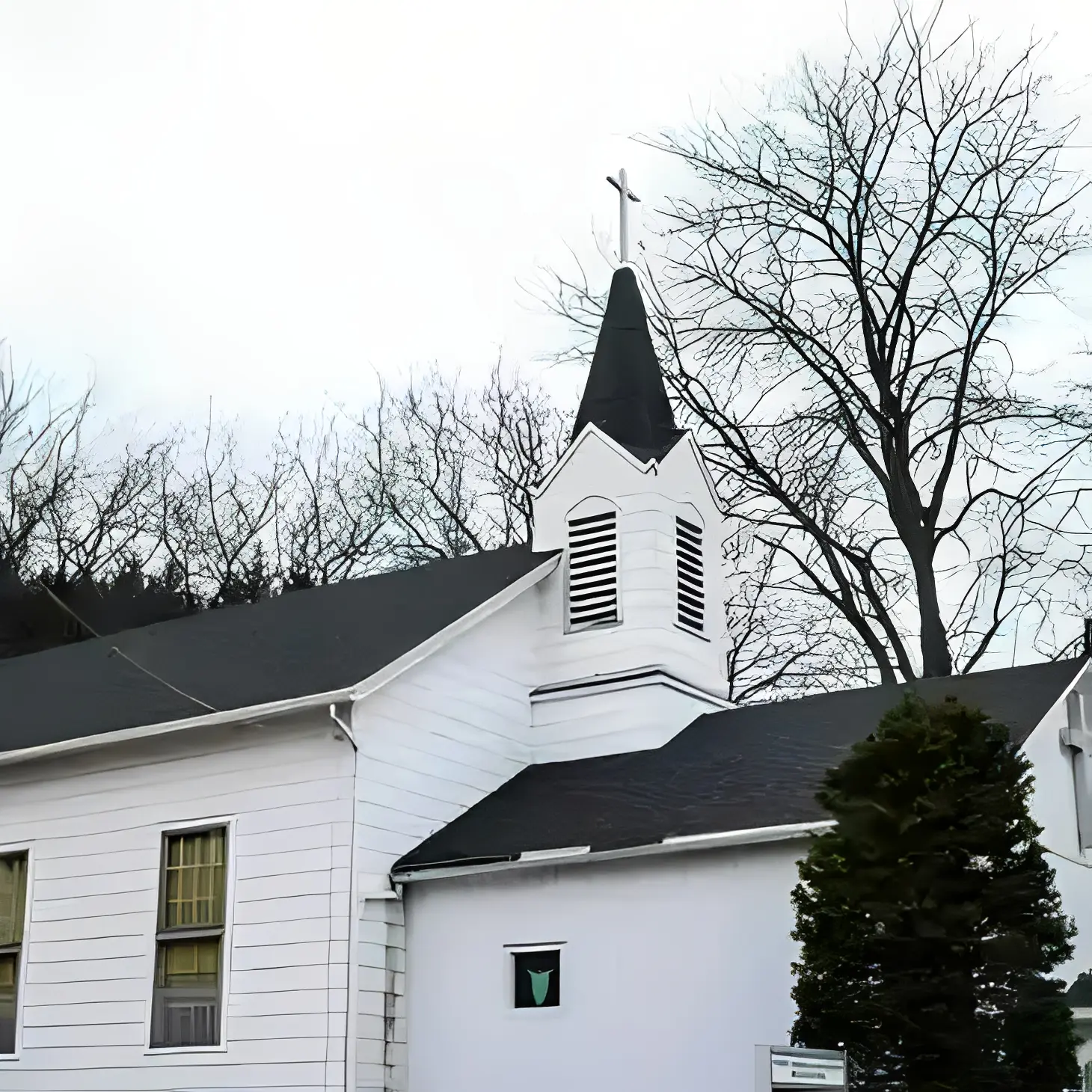 White church with steeple and trees