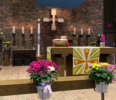 Altar decorated with flowers and candles in a church.