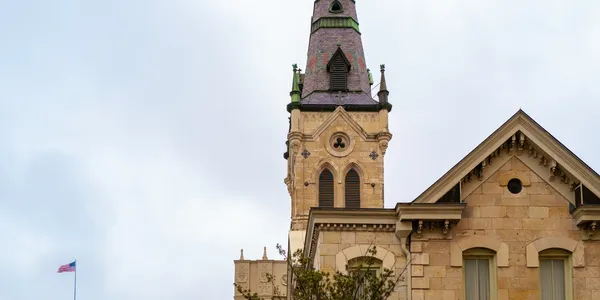 Gothic-style tower under cloudy sky