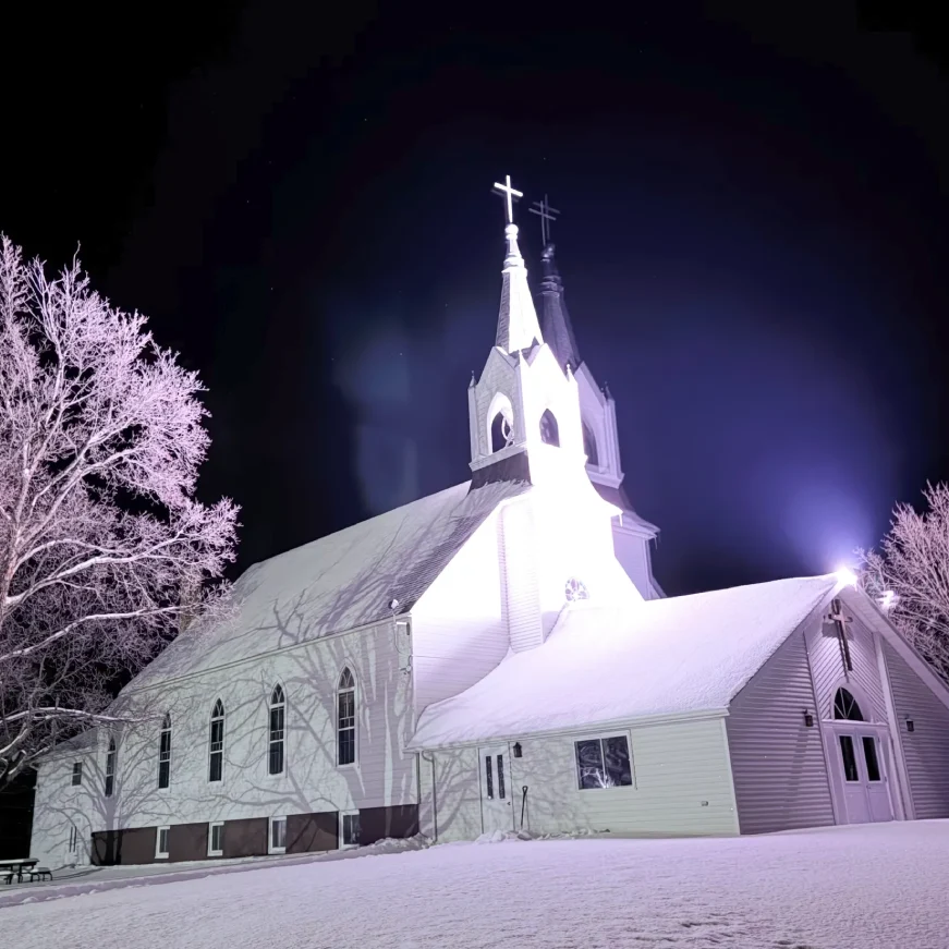 Snow-covered church under night sky